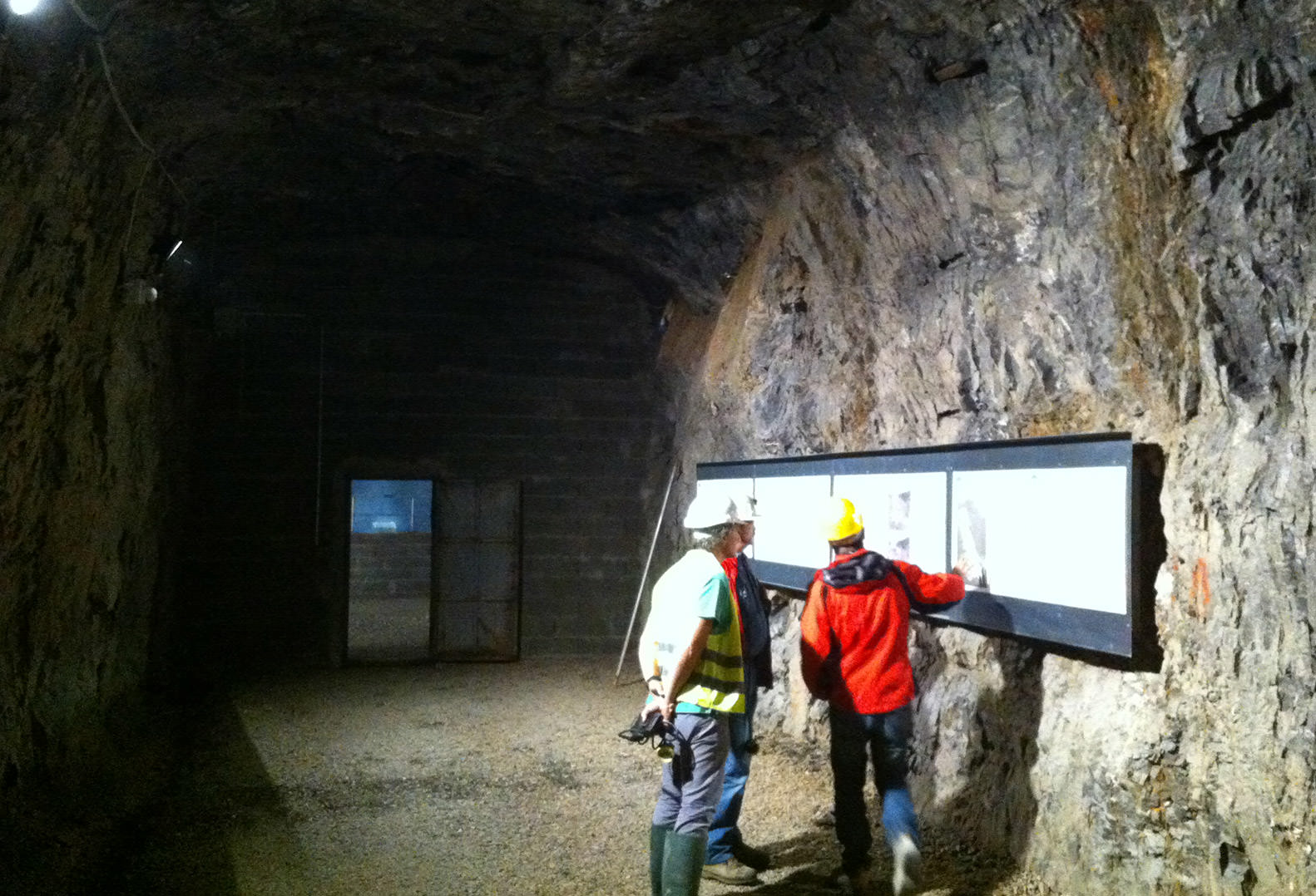 Three men performing underground quarry inspection