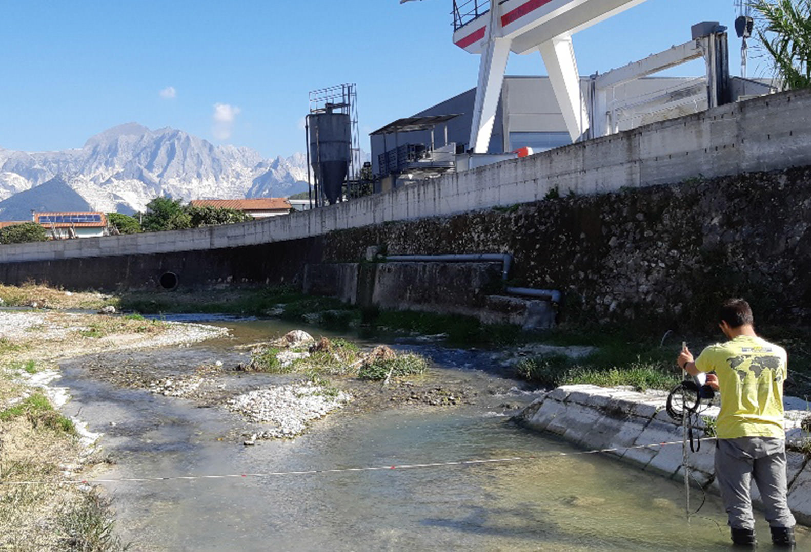 Man stands in water and performs stream gauging